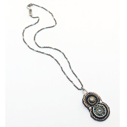 Necklace with a decorative pendant on a white background
